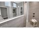 Bathroom shower boasts a glass enclosure, sleek gray tiling, and a built-in tiled bench at 19341 Sumrall Pl, Westfield, IN 46074