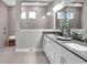 Modern bathroom with double sinks, quartz counters, and tiled shower at 19341 Sumrall Pl, Westfield, IN 46074