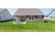 Spacious backyard featuring a covered patio and a well-maintained lawn at 19357 Sumrall Pl, Westfield, IN 46074