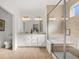 A full bath offers a double sink vanity and walk-in shower with a glass door and shower bench at 19357 Sumrall Pl, Westfield, IN 46074