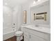 Bright bathroom featuring a shower-tub combo, a white vanity, and modern decorative wall art at 19357 Sumrall Pl, Westfield, IN 46074