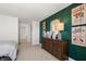 Bedroom view with dark green accent wall, dresser, and decor at 19357 Sumrall Pl, Westfield, IN 46074