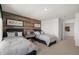 Comfortable bedroom with twin beds, wood accent wall, and neutral carpeting at 19357 Sumrall Pl, Westfield, IN 46074
