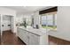 Open-concept kitchen featuring a large island with bar seating, white cabinets, and stainless steel appliances at 19357 Sumrall Pl, Westfield, IN 46074