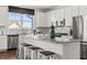 Bright eat-in kitchen featuring white cabinets, stainless appliances, granite counters, and large central island at 19357 Sumrall Pl, Westfield, IN 46074