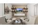 Inviting living room featuring comfortable seating, floating shelves and stylish decor at 19357 Sumrall Pl, Westfield, IN 46074