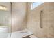 Tiled shower with bench and grab bar features a window for natural light and modern fixtures at 19357 Sumrall Pl, Westfield, IN 46074