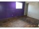 Bedroom with purple walls and wood floors needing work at 2003 Main St, Beech Grove, IN 46107