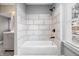Bathroom featuring tub-shower with decorative tile and a view from the window at 2005 E Maryland St, Indianapolis, IN 46201