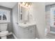 Bathroom featuring vanity, toilet, mirror, and decorative lighting at 2005 E Maryland St, Indianapolis, IN 46201