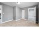 Bedroom with neutral carpet, gray walls, and white trim, offering closet and bathroom access at 2005 E Maryland St, Indianapolis, IN 46201