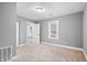 Bedroom with neutral carpet, gray walls, and white trim, featuring two windows at 2005 E Maryland St, Indianapolis, IN 46201
