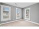 Bedroom with neutral carpet, gray walls, and three windows for plenty of sunlight at 2005 E Maryland St, Indianapolis, IN 46201