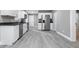 Bright kitchen features white cabinets, stainless appliances, and gray wood-look floors at 2005 E Maryland St, Indianapolis, IN 46201