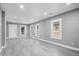 Spacious open concept living area with modern flooring, multiple windows, and neutral paint tones at 2005 E Maryland St, Indianapolis, IN 46201