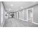 Expansive open-plan living area offering seamless flow to the kitchen and hallway, enhanced by modern gray flooring at 2005 E Maryland St, Indianapolis, IN 46201