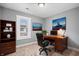 Functional home office space featuring a classic wooden desk, ample shelving, and natural light at 2005 E Maryland St, Indianapolis, IN 46201