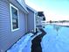 Exterior view of home showcasing gray siding, snowy yard and walkway at 2103 Twelve Oaks Dr, Shelbyville, IN 46176