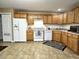 Well-equipped kitchen with wooden cabinets, appliances, and a pantry for ample storage at 2103 Twelve Oaks Dr, Shelbyville, IN 46176