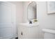 Updated bathroom with white vanity, black matte faucet, and an arched mirror at 262 N Tremont St, Indianapolis, IN 46222