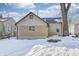 House exterior showcasing a two-toned design, snowy yard, and mature tree at 2850 S Lockburn, Indianapolis, IN 46241