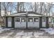 Two-car garage with white doors and a snowy roof at 3135 E Southport Rd, Indianapolis, IN 46227