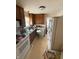 Kitchen with white appliances and wood cabinets at 3222 W Minnesota St, Indianapolis, IN 46241