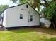 Exterior view showing a well-kept backyard and white siding, complemented by black trim details at 3501 Caroline Ave, Indianapolis, IN 46218
