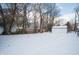 Snowy backyard with detached shed and privacy fence at 3501 Caroline Ave, Indianapolis, IN 46218