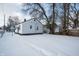 Winter view of backyard, featuring a home and snow-covered ground at 3501 Caroline Ave, Indianapolis, IN 46218