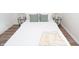 Simple bedroom with a comfortable bed and wood flooring at 3501 Caroline Ave, Indianapolis, IN 46218