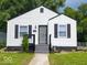 Charming single-story home featuring a white exterior, black shutters, and a well-maintained front yard at 3501 Caroline Ave, Indianapolis, IN 46218