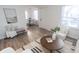 Living room with a coffee table and view into dining area at 3501 Caroline Ave, Indianapolis, IN 46218