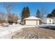 Detached garage with double doors, located on a snowy property at 4202 W Mooresville Rd, Indianapolis, IN 46221