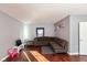 Bright living room featuring hardwood floors and L-shaped sofa at 4202 W Mooresville Rd, Indianapolis, IN 46221