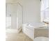 Bathroom with corner bathtub, shower, and tile flooring at 5334 Thrasher Dr, Indianapolis, IN 46254