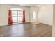 Dining room features wood-look floors, large window with red curtains, and an entryway at 5334 Thrasher Dr, Indianapolis, IN 46254