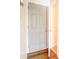 Simple hallway with a closed grey door and wood flooring at 5334 Thrasher Dr, Indianapolis, IN 46254