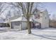 Two-story house with gray siding, red shutters, and a snowy front yard at 5334 Thrasher Dr, Indianapolis, IN 46254