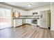 Kitchen with white cabinets, stainless steel appliances, and wood-look floors at 5334 Thrasher Dr, Indianapolis, IN 46254