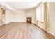 Living room features a corner fireplace, large window, and wood-look floors at 5334 Thrasher Dr, Indianapolis, IN 46254