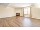 Spacious living room featuring hardwood floors, a fireplace, and large windows at 5334 Thrasher Dr, Indianapolis, IN 46254