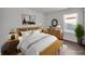 Virtually staged bedroom with a king-size bed and wood accents at 5705 Tansy Ct, Indianapolis, IN 46203