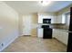 Efficient kitchen with white cabinets and black appliances at 67 W Brookville Rd, Fountaintown, IN 46130