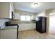 Kitchen boasts white cabinets, granite counters, and black appliances at 67 W Brookville Rd, Fountaintown, IN 46130