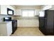 White kitchen with black appliances and granite countertops at 67 W Brookville Rd, Fountaintown, IN 46130