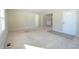 Bright living room with carpeted floors, showing entryway and built-in hutch at 67 W Brookville Rd, Fountaintown, IN 46130