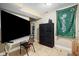 Finished basement room with a large TV and dresser at 714 Berkley Rd, Indianapolis, IN 46208