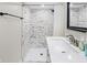 Basement bathroom with marble-look tile and modern vanity at 714 Berkley Rd, Indianapolis, IN 46208