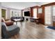 Living room with hardwood floors, wood-paneled walls, fireplace at 714 Berkley Rd, Indianapolis, IN 46208